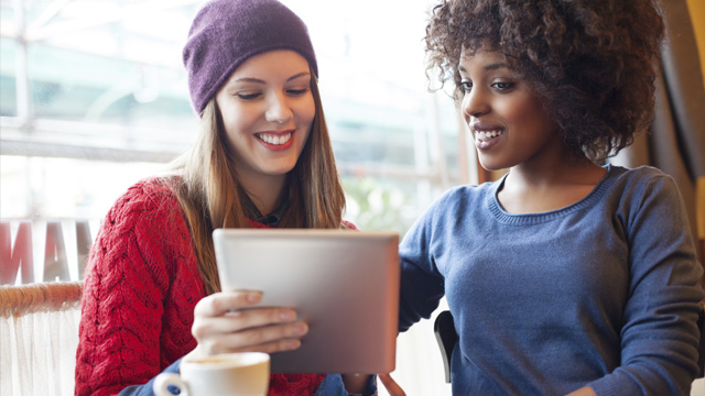 Two women using a tablet