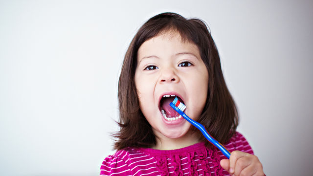 Little girl brushing her teeth