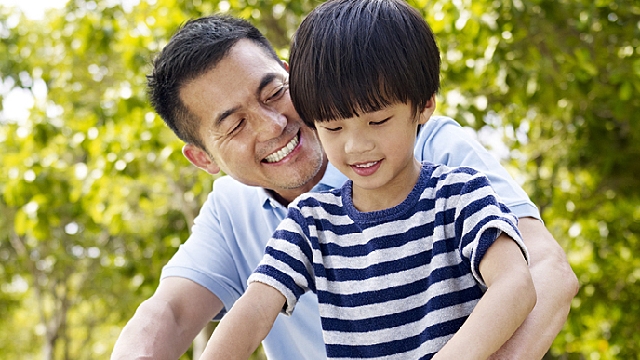 father is telling son how to pick the best toothbrush