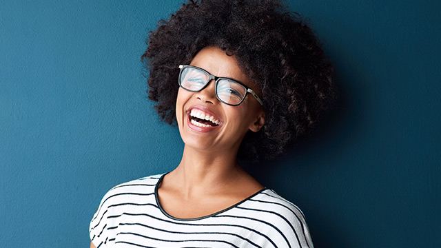 Girl smiling brightly after using a teeth whitening product 