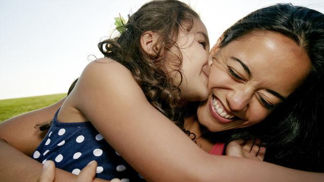daughter kissing mum on cheek